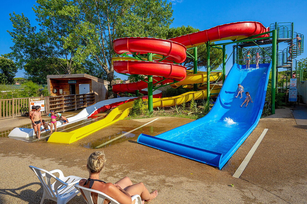 Toboganes acu�ticos coloridos y ni�os felices en el camping CAPFUN Aubr�des en Puget sur Argens (83).