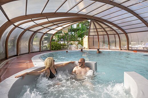 Piscina cubierta, jacuzzi con pareja en el camping CLICOCHIC Baie de Douarnenez, Poullan-sur-Mer.