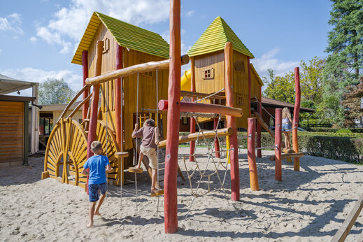 �rea de juegos de madera con ni�os en el camping CAPFUN Citta di Angera VA.