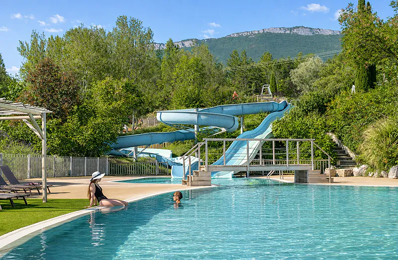 Piscina exterior, toboganes acu�ticos y tumbonas en el camping CLICOCHIC Couriou en Recoubeau-Jansac.