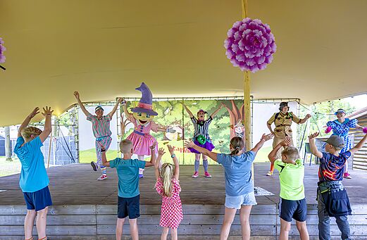 Niños y animadores disfrazados en un espectáculo de animación en el camping CAPFUN De Belten a Rheeze.