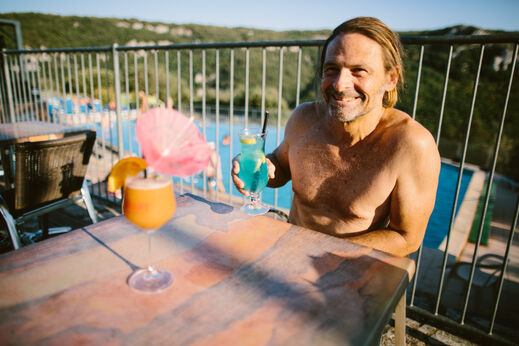 Hombre sonriente en el camping LIBRANOO Naturiste Sabliere en Barjac (30).