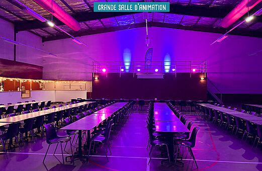 Sala de animación con mesas en el camping VAGUES OCEANES Elysée en Le Grau du Roi (30).