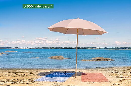 Sombrilla y toallas en la playa de arena fina cerca del camping CLICOCHIC Etoile de Mer en Asserac (44).