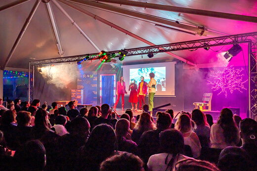 Espectáculo de animación con artistas en el escenario y público en el camping CAPFUN Fredland.