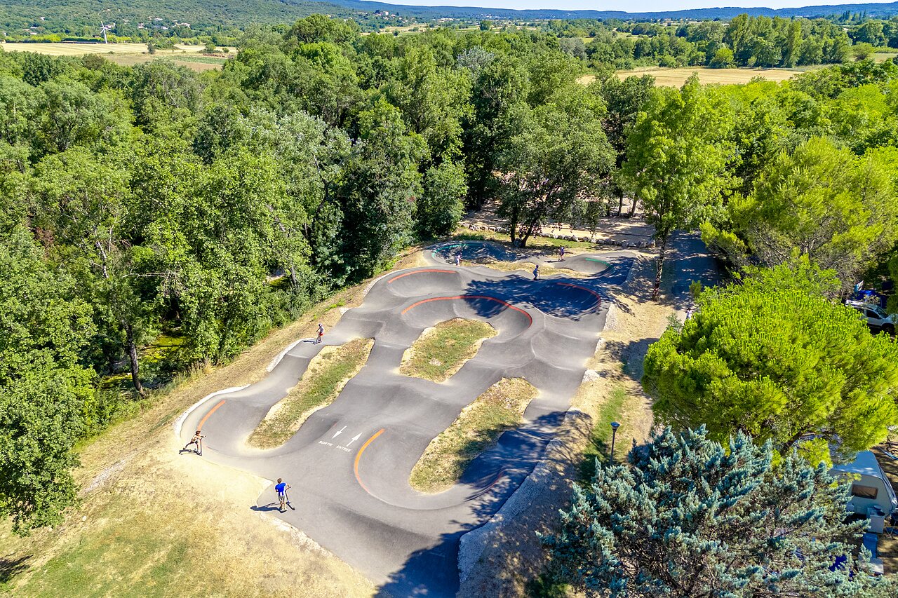 Pista de pump track moderna para bicicletas y patinetes en el camping CAPFUN Fumades en ALLEGRE-LES-FUMADES (30).