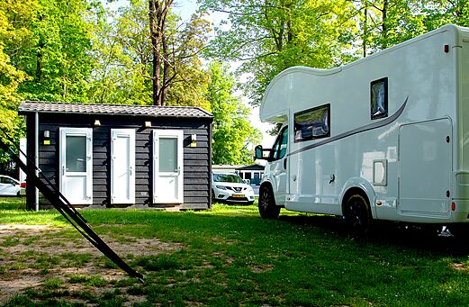 Bloque sanitarios y Mobil-home blanco en parcela en CAPFUN Hirondelle Oteppe.