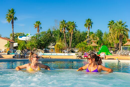 Jacuzzi de piscina con dos mujeres sonrientes en el camping CAPFUN Lou Village Vendres.