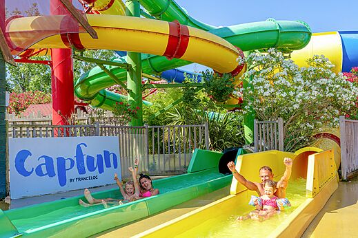 Familia feliz en toboganes acu�ticos y piscina en el camping CAPFUN Mael en ARGELES SUR MER (66)