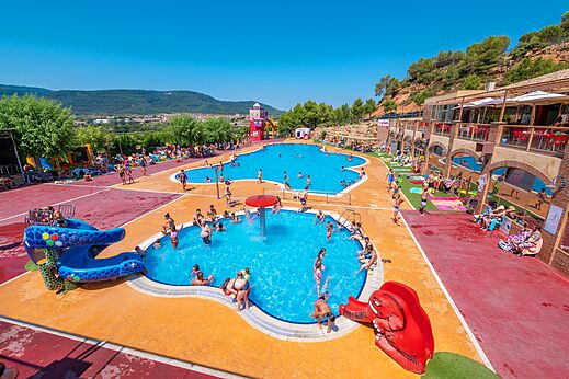 Gran piscina exterior con toboganes y juegos acuáticos en el camping CAPFUN Montblanc Park en Montblanc (43).