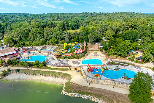 Vista aérea del parque acuático, piscinas y toboganes en el camping CAPFUN Moulinal en BIRON (24).
