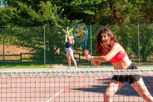 J�venes jugando al tenis en la pista del camping CAPFUN Moulinal en BIRON (24).