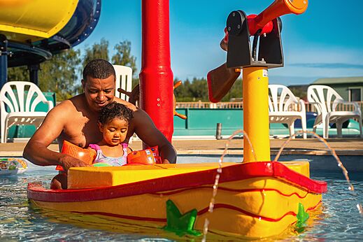 Ni�o y padre juegan en el �rea de juegos acu�ticos del camping CAPFUN Pachy en FOSSES LA VILLE.