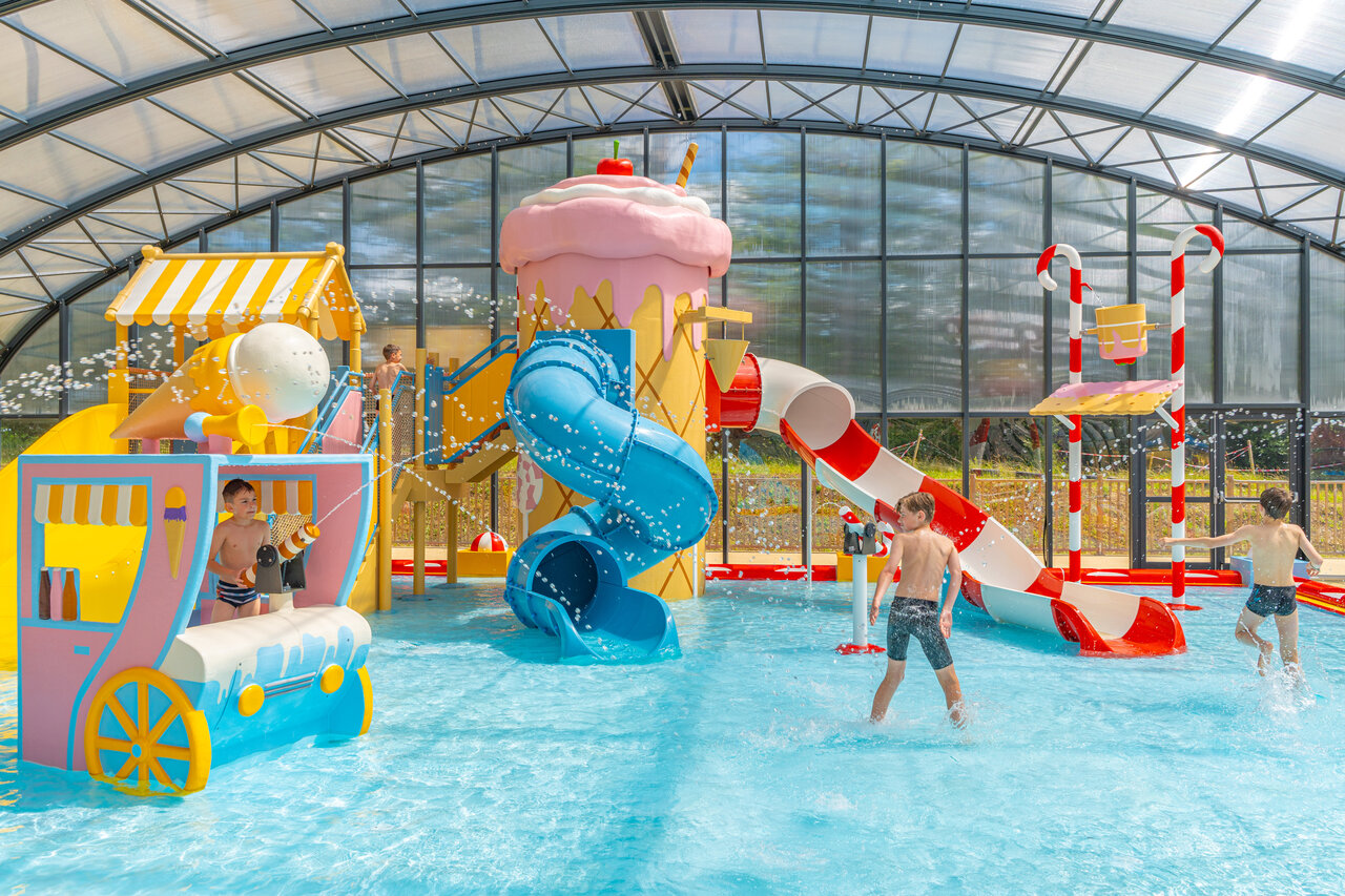 Piscina cubierta con toboganes y juegos de agua en el camping CAPFUN Palais de Gaufrette en R�mering les Puttelange (57).
