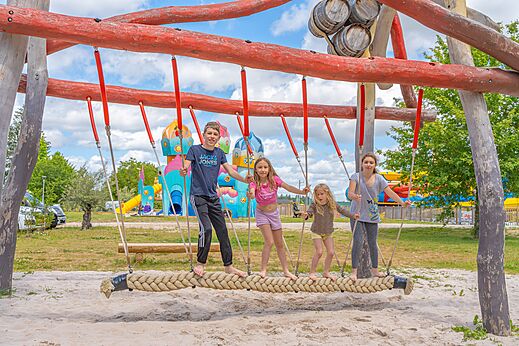 Ni�os en columpio de cuerda del parque infantil en el camping CAPFUN Palais de Gaufrette en R�mering les Puttelange (57).
