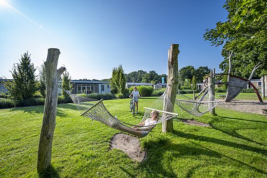 Hamacas de relax y zona de juegos infantiles en el camping CAPFUN Ponderosa en Ulicoten.