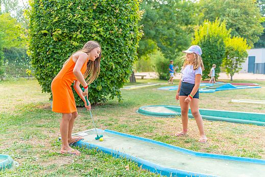 Minigolf con dos niñas jugando en el camping CAPFUN Les Portes du Beaujolais en Anse (69).