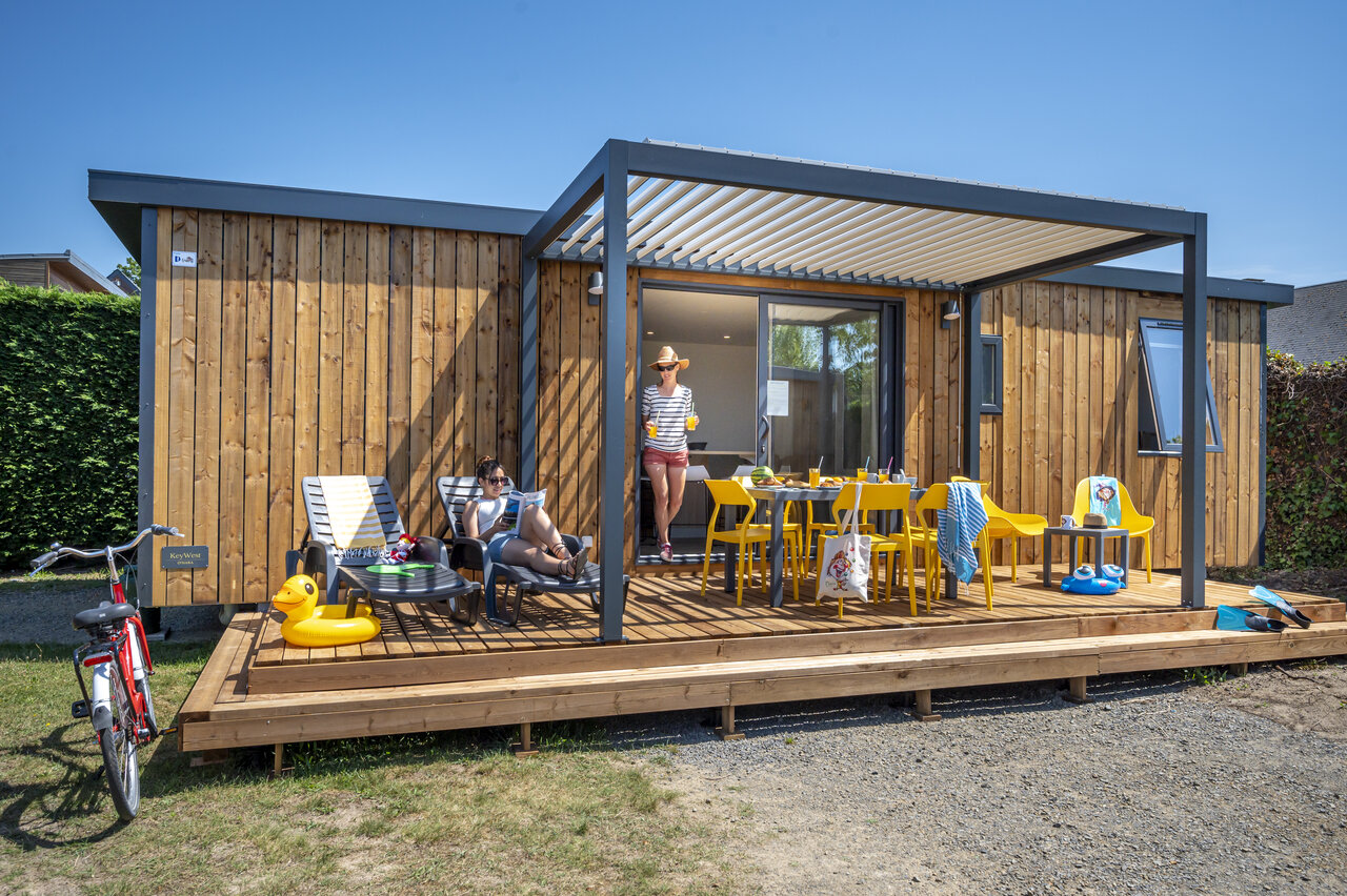 Mobil-home moderno, terraza de madera, familia en el camping CAPFUN La Route Blanche en Breville sur Mer (50).