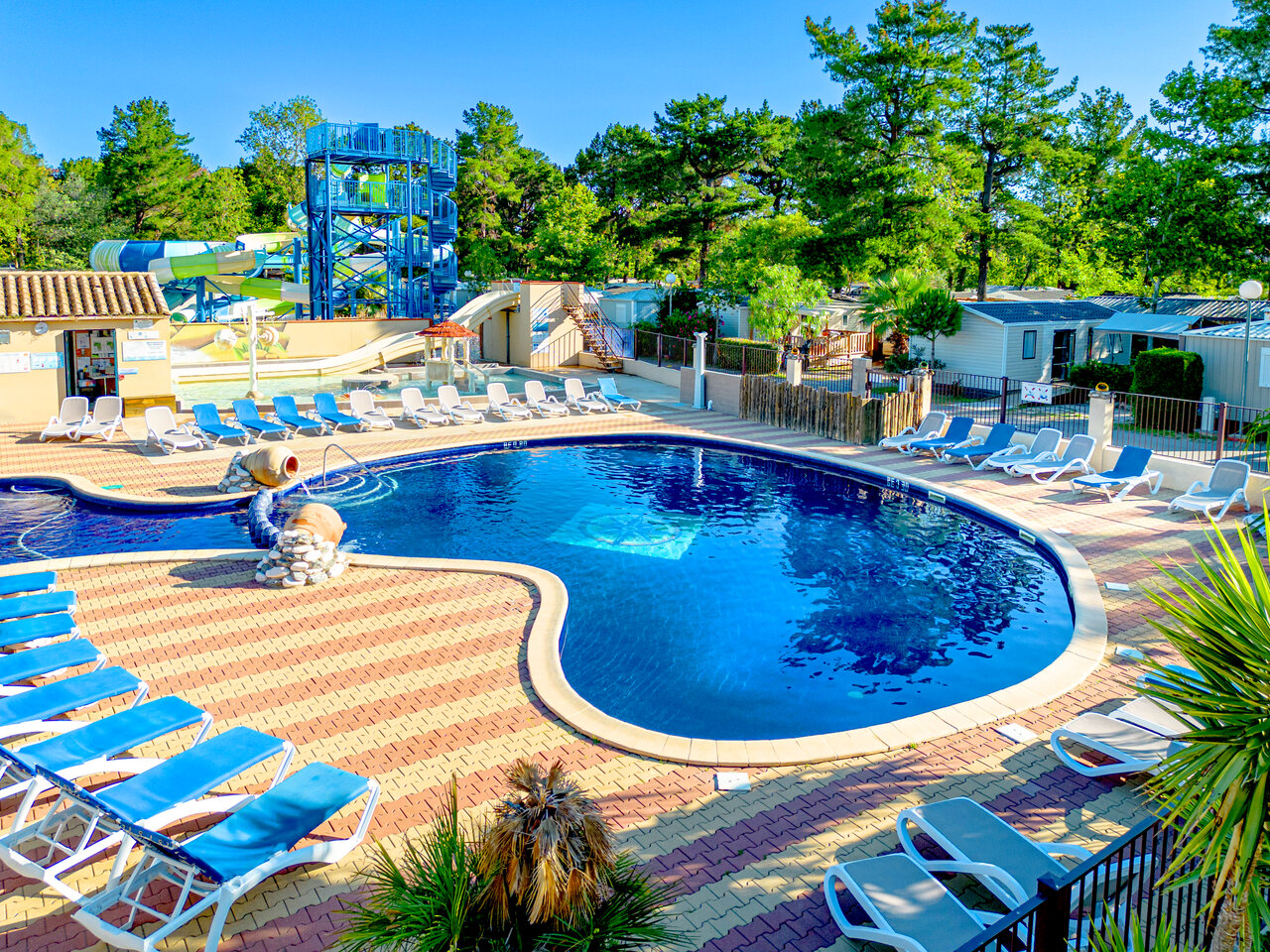 Piscina exterior con toboganes acu�ticos y tumbonas en el camping CLICOCHIC Texas en Argel�s sur Mer (66).