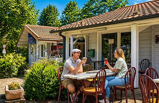 Pareja bebiendo en la terraza del bar, recepci�n en el camping CLICOCHIC Verte Vall�e en XONRUPT LONGEMER (88).