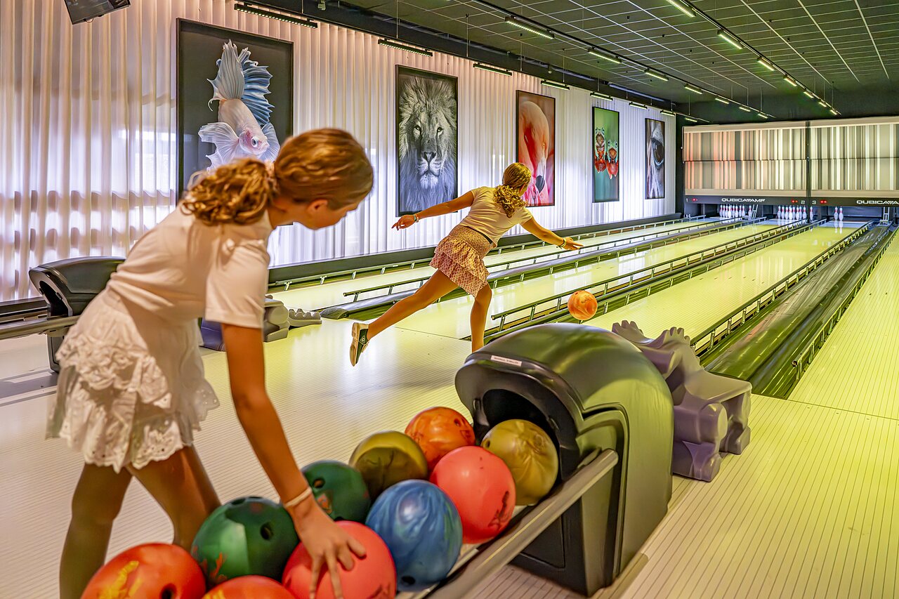 Dos ni�as jugando a los bolos en una pista moderna en el camping CAPFUN het Winkel en Winterswijk.
