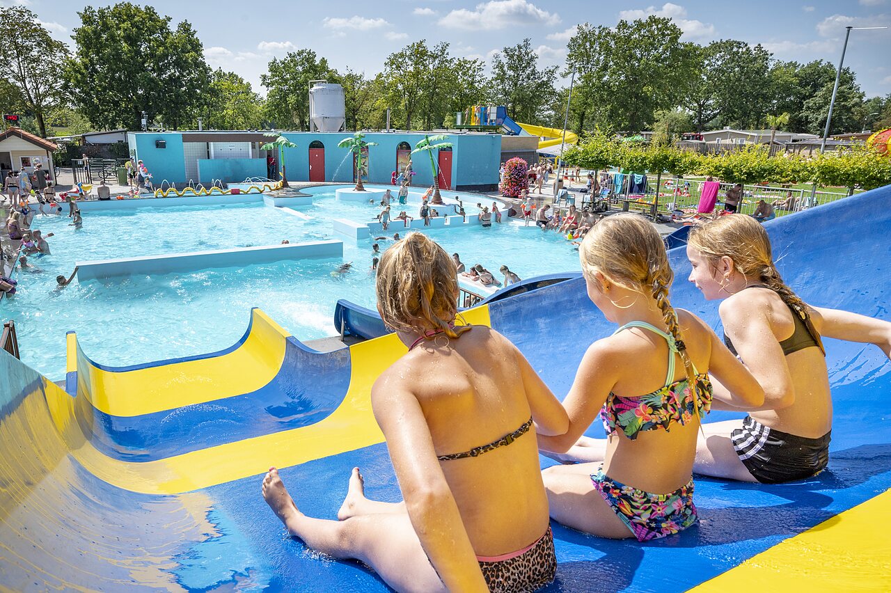 Ni�os en tobog�n acu�tico, piscina exterior animada en el camping CAPFUN de Wondermolen en Molenschot.